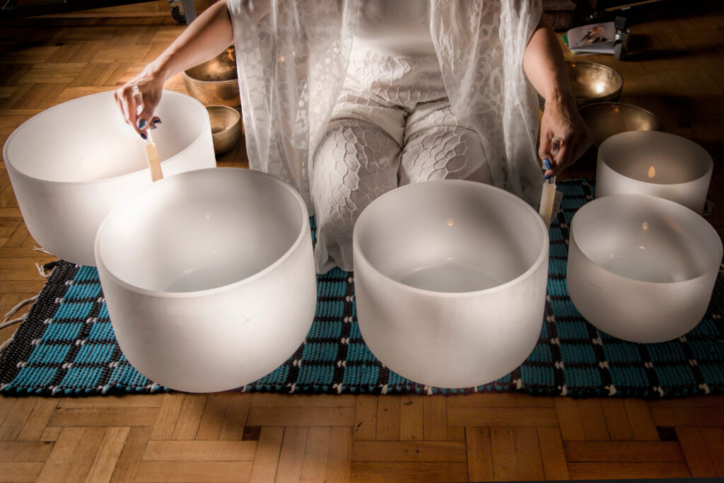 Quartz Bowls and Woman in Sound healing therapy and meditation sound bath